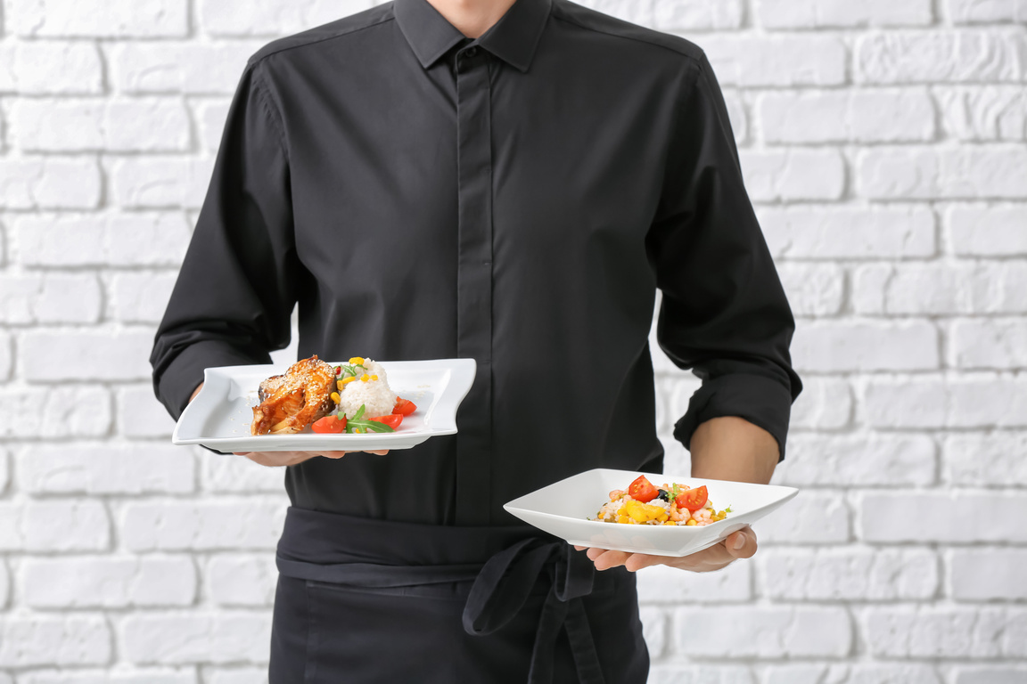 Waiter Holding Plates of Food